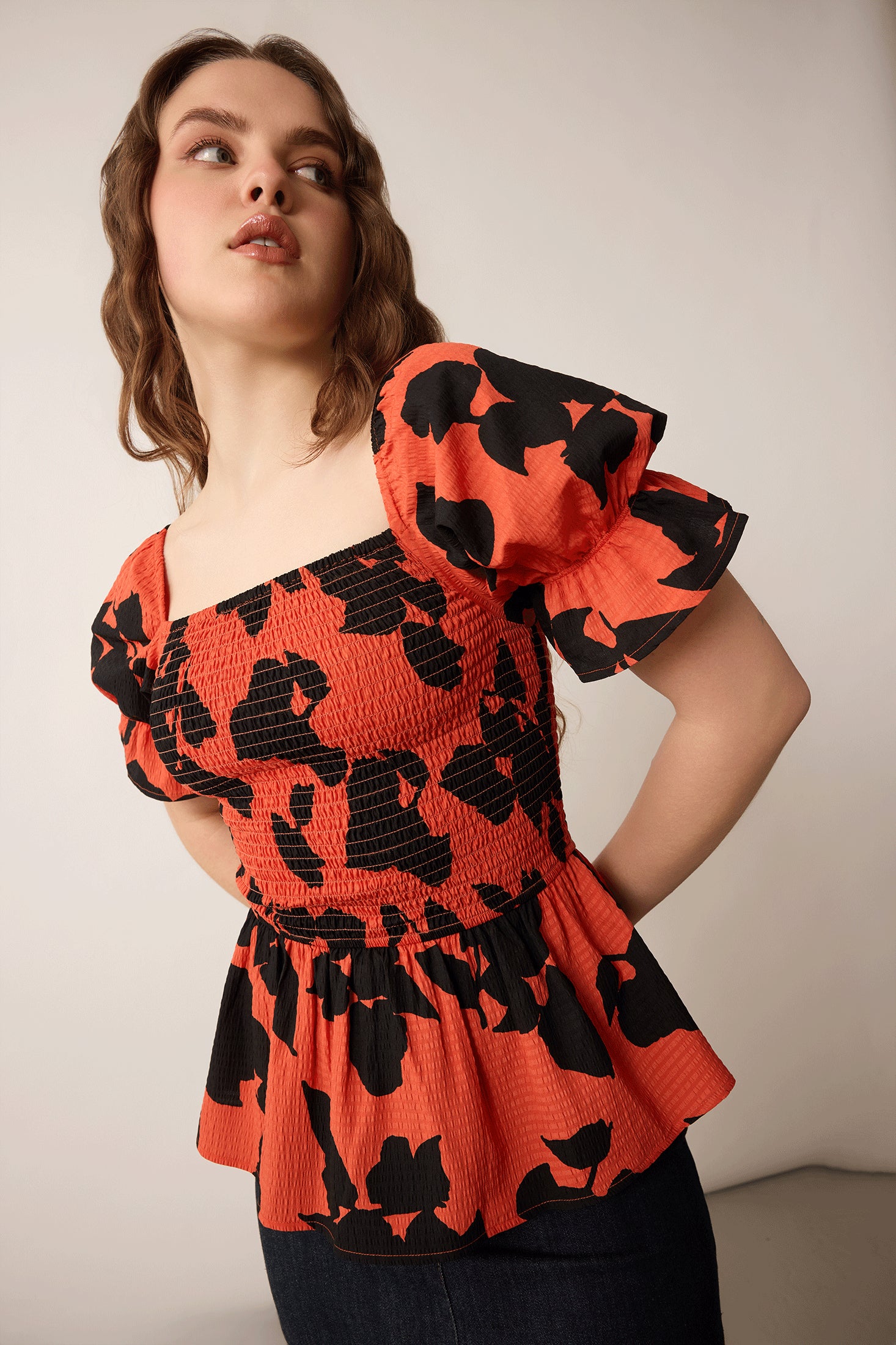 Bailey in Bold Peplum Top In Orange and Black